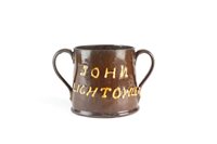 Lot 314 - A 19th century twin-handled named and dated frog mug