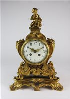 Lot 100 - A Louis XV style gilt metal mantel clock