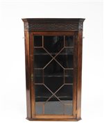Lot 290 - A mahogany hanging corner cabinet in George III style