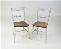 Lot 453 - A set of seven cream painted elm seat bar back kitchen chairs