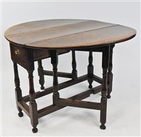 Lot 590 - An oak drop leaf single gateleg action table