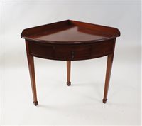 Lot 468 - An Edwardian mahogany bow-front corner washstand