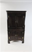 Lot 247 - A George III oak and mahogany crossbanded free standing straight front corner cupboard