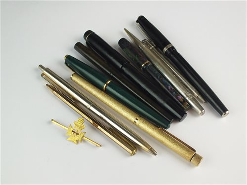 Lot 70 - A regimental pin and a collection of pens