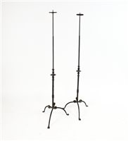 Lot 261 - A decorative pair of wrought iron candle stands