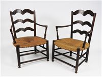 Lot 264 - A pair of fruitwood low ladder back rush seat open armchairs