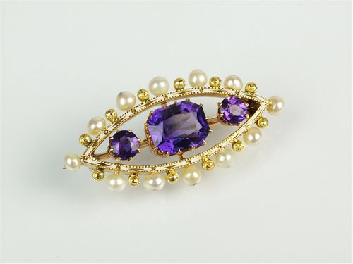 Lot 174 - An early 20th century amethyst, enamel and pearl brooch