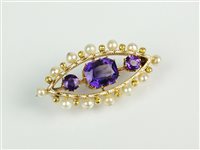 Lot 174 - An early 20th century amethyst, enamel and pearl brooch
