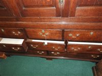 Lot 619 - A George III oak house keepers cupboard