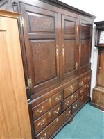 Lot 619 - A George III oak house keepers cupboard