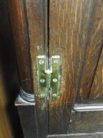 Lot 619 - A George III oak house keepers cupboard