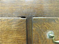 Lot 619 - A George III oak house keepers cupboard
