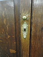 Lot 619 - A George III oak house keepers cupboard