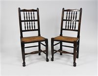 Lot 252 - A set of four ash spindle back rush seat dining chairs