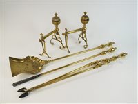 Lot 137 - A pair of brass fire dogs and a set of fire tools