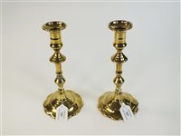 Lot 121 - A pair of George III brass candlesticks