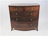 Lot 583 - A George III mahogany and chequer strung bow front chest