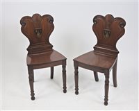 Lot 273 - A pair of early 19th century mahogany hall chairs
