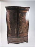 Lot 253 - A mahogany bow front wardrobe