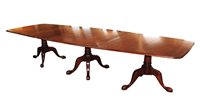 Lot 283 - A George III style mahogany tri-pillar dining table