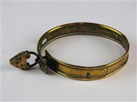 Lot 480 - A brass dog collar and padlock, 19th century