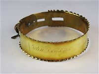 Lot 488 - A plain brass dog collar with serrated edge