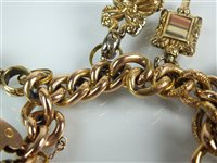 Lot 118 - A charm bracelet with attached fobs