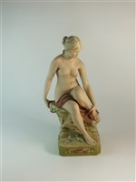 Lot 90 - A Royal Dux figure of a nude female seated upon a rocky base