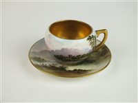 Lot 57 - A Coalport landscape painted cabinet cup and saucer