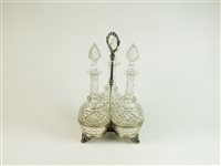 Lot 82 - A set of three decanters on trefoil silver-plated stand and four further decanters