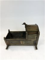 Lot 111 - An oak cradle in George III style, with hinged canted hood, with panelled sides and short skates