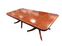 Lot 281 - A reproduction and crossbanded mahogany finished twin pillar dining table