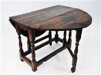 Lot 144 - An oak single gate leg action table