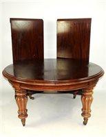 Lot 818 - A mid Victorian mahogany pull out action dining table