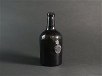 Lot 5 - A glass wine bottle with 'John Winn Jr' seal