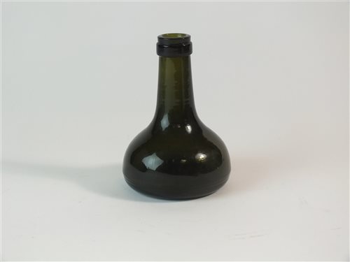Lot 21 - Small dark green glass bottle