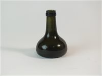 Lot 21 - Small dark green glass bottle