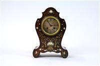 Lot 240 - A 19th century French rosewood brass and ivory inlaid mantle clock