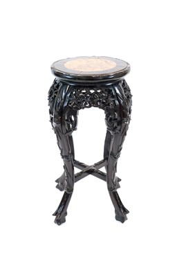 Lot 520 - A 19th century Chinese carved hardwood jardinière stand with an inset polished marble top