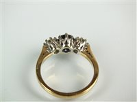 Lot 140 - A three stone sapphire and diamond ring