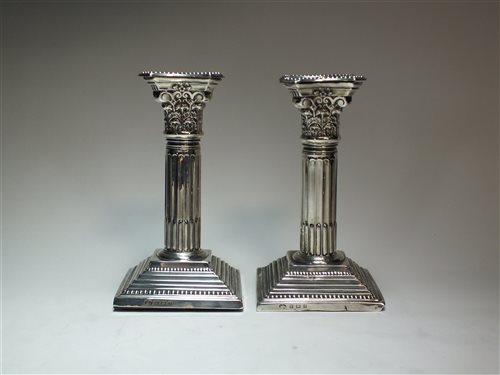 Lot 80 - A pair of Corinthian column silver candlesticks