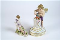 Lot 101 - A Plaue figure of Cupid igniting hearts and a figure of a putto with wheelbarrow