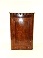 Lot 287 - A George III country inlaid oak corner cupboard