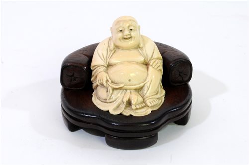 Lot 256 - A Japanese carved ivory figure of Hotei, Meiji period