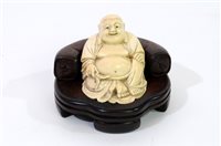 Lot 256 - A Japanese carved ivory figure of Hotei, Meiji period