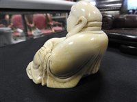 Lot 256 - A Japanese carved ivory figure of Hotei, Meiji period