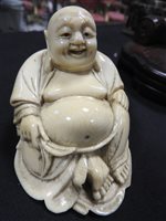 Lot 256 - A Japanese carved ivory figure of Hotei, Meiji period