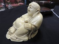 Lot 256 - A Japanese carved ivory figure of Hotei, Meiji period