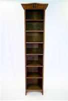 Lot 380 - An oak Arts and Crafts tall narrow bookcase