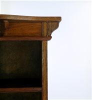 Lot 380 - An oak Arts and Crafts tall narrow bookcase